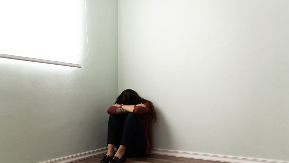 Emotional Exhaustion Woman Alone Room - DR. ARUNAVA DATTA Blog